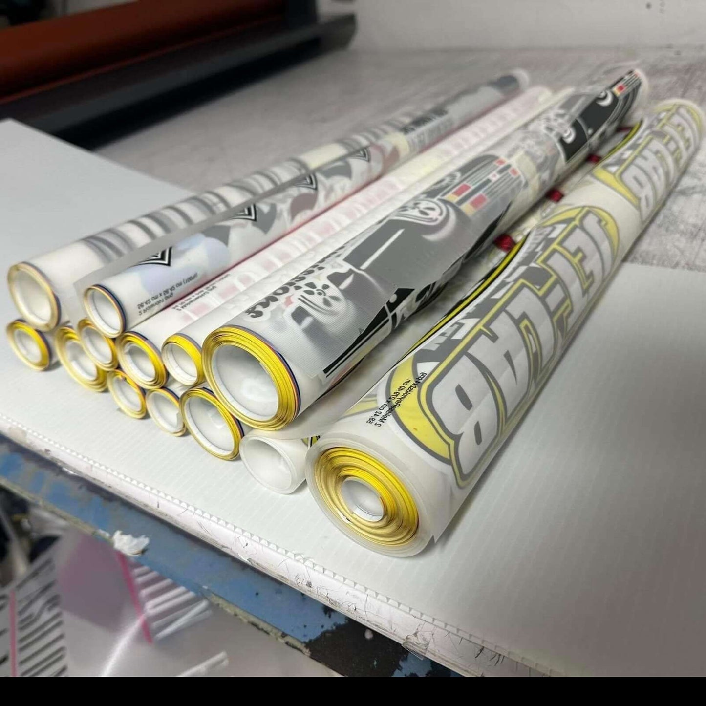 Rolls of printed DTF gang sheets for custom apparel design and vibrant printing.